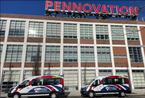 Two Penn Transit EV shuttles in front of Pennovation Works