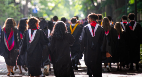 The back of Penn graduates in commencement regalia